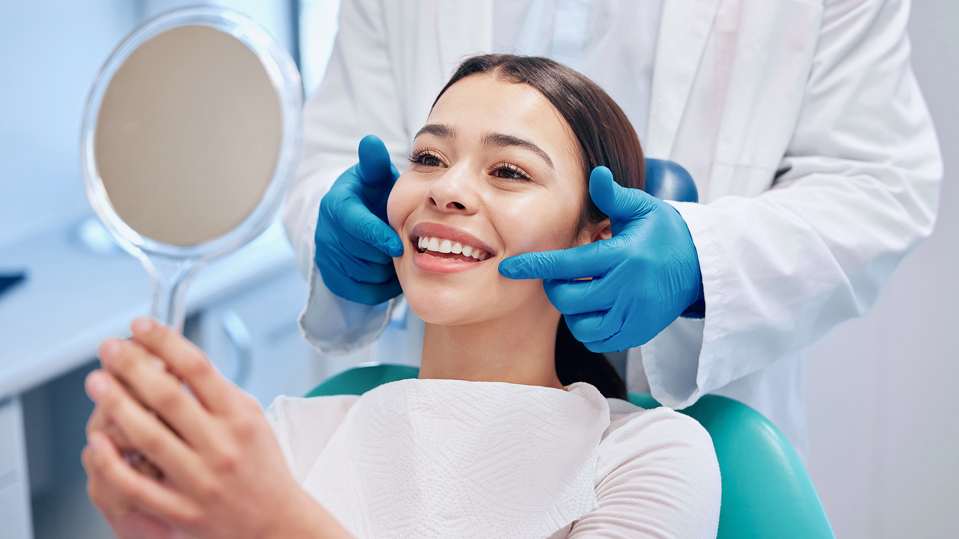 A dental professional performing a teeth cleaning procedure on a patient.