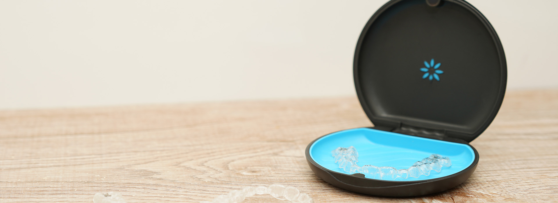 An image of a smart home device, specifically an Amazon Echo Show, with its screen displaying the weather and set on a wooden surface.