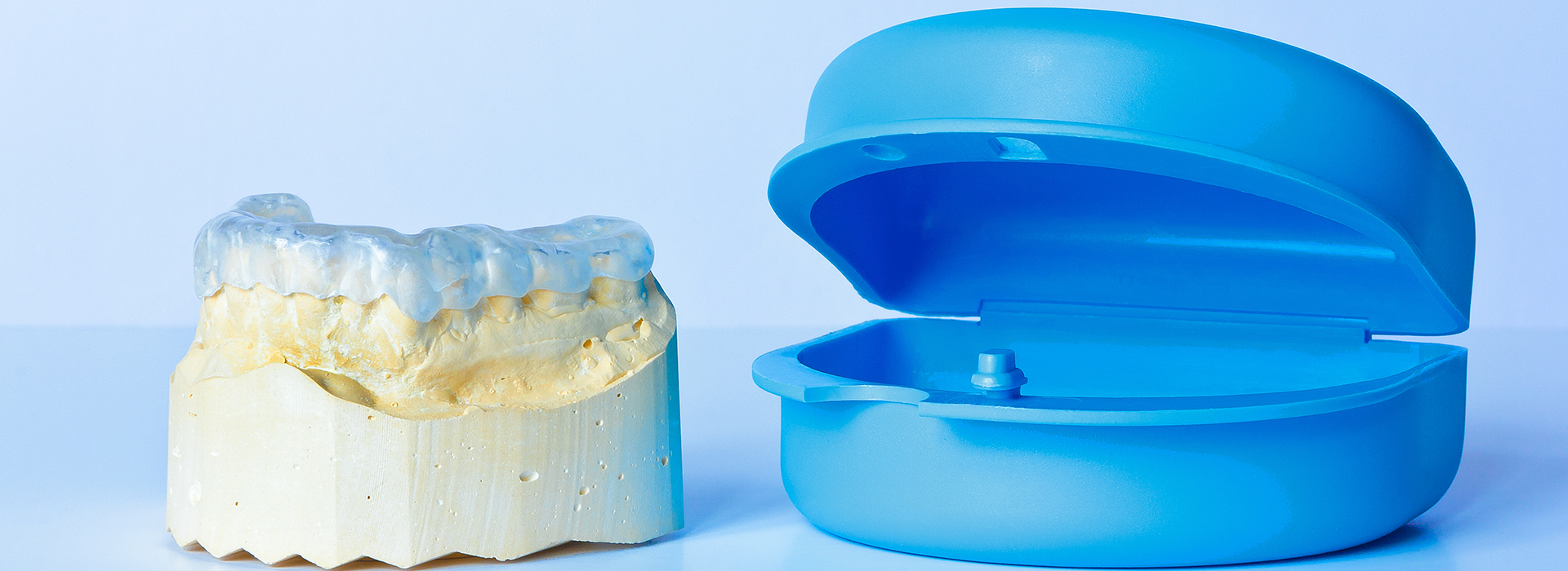 An image showcasing a dental implant and its corresponding plastic model.